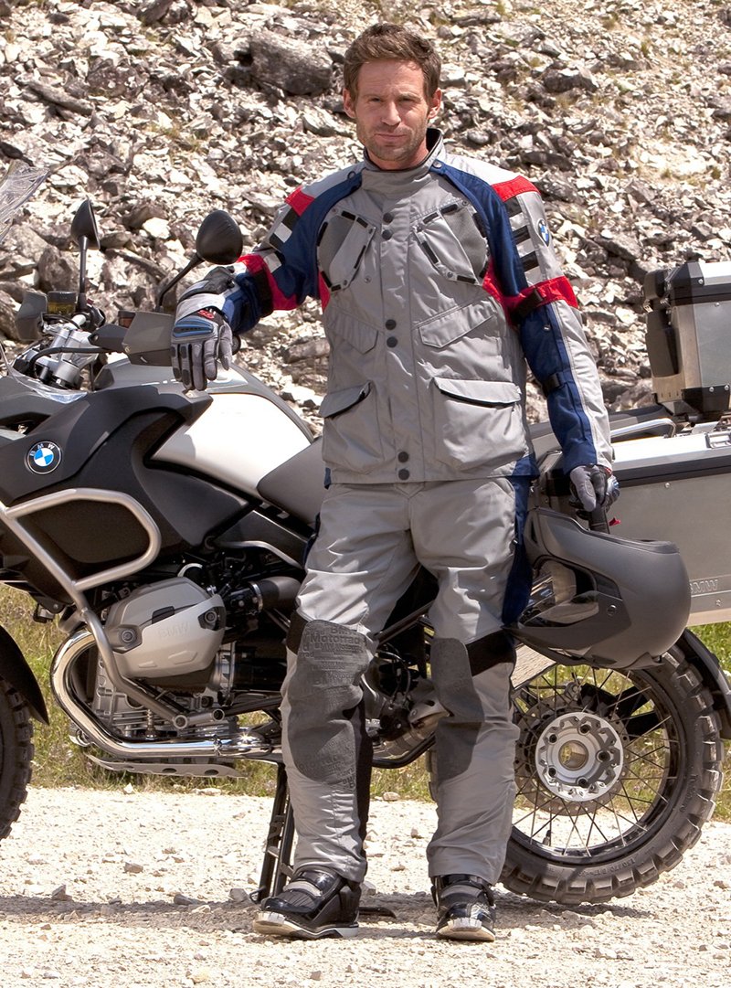 Guy wearing BMW two-piece textile suit next to GS